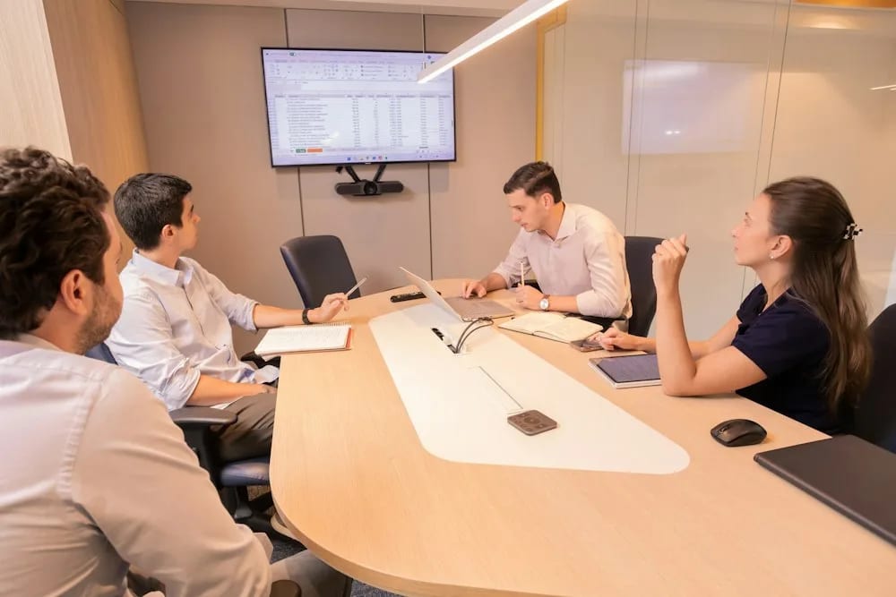 Business professionals reviewing information around a conference table